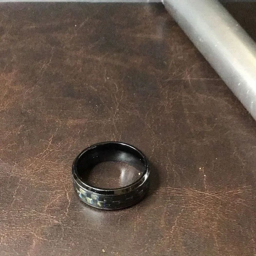 Nice stainless black ring with shimmering blue and green center etchings size 10